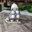 Dziecko dziewczynka na sankach zawieszka szara 8cm 